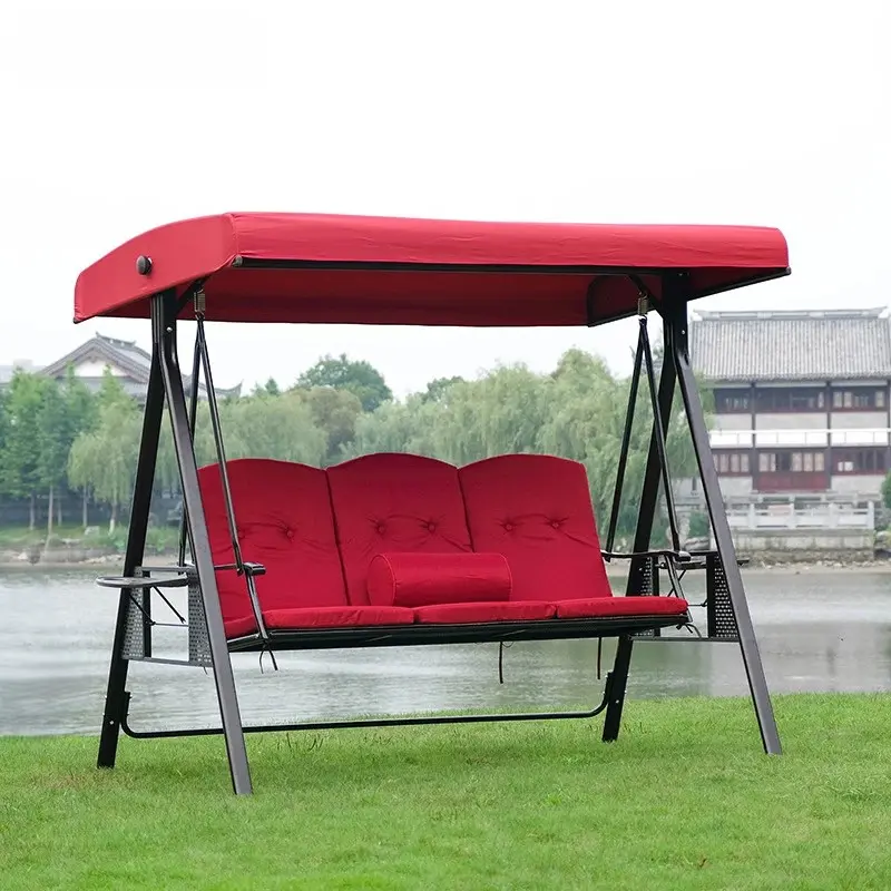 Two elegant canopy swing chairs in a lush outdoor setting