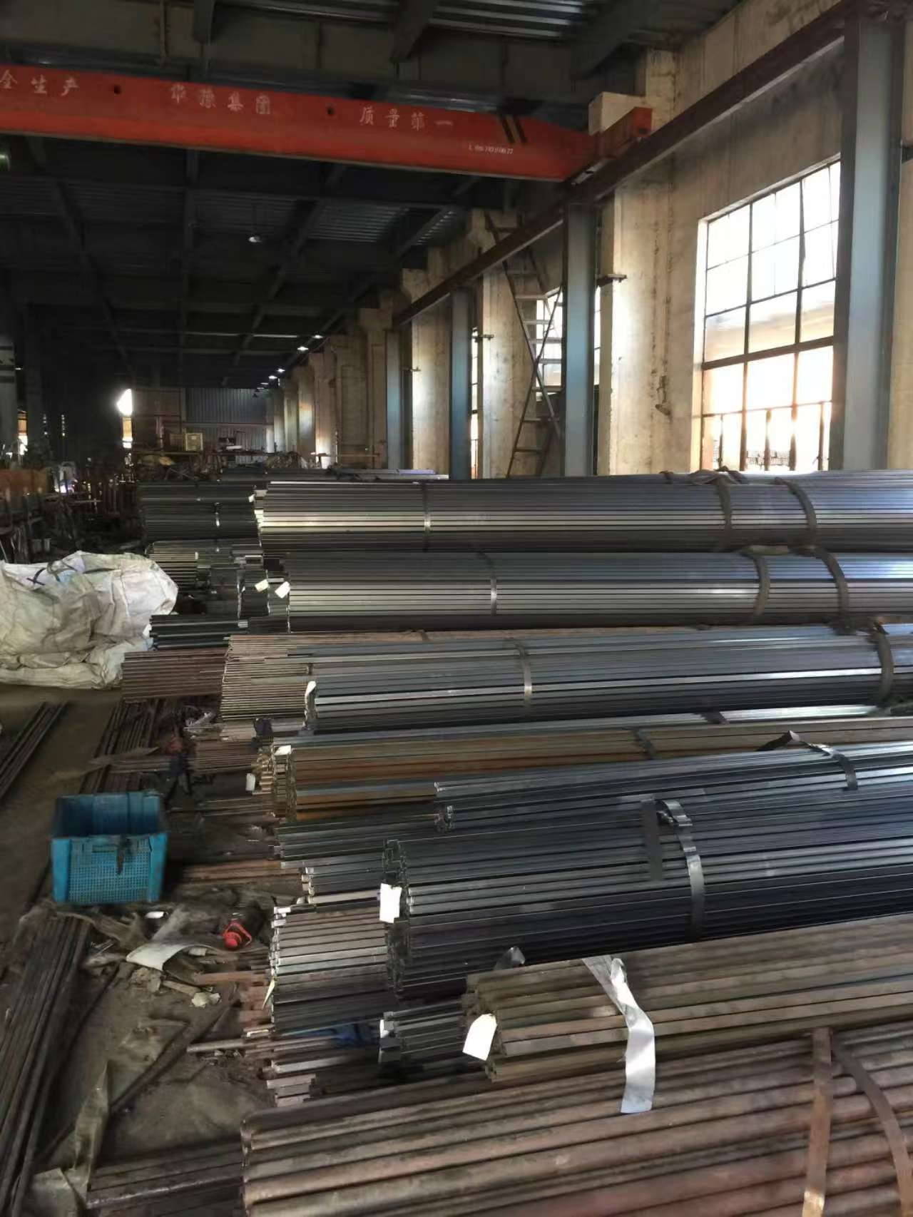 Inside view of a factory producing metal pipes for outdoor furniture.