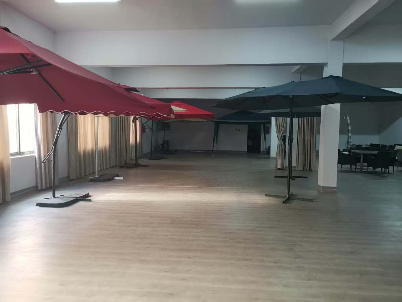 Interior view of Patiofurnituresco's factory showroom featuring a variety of outdoor furniture displays.