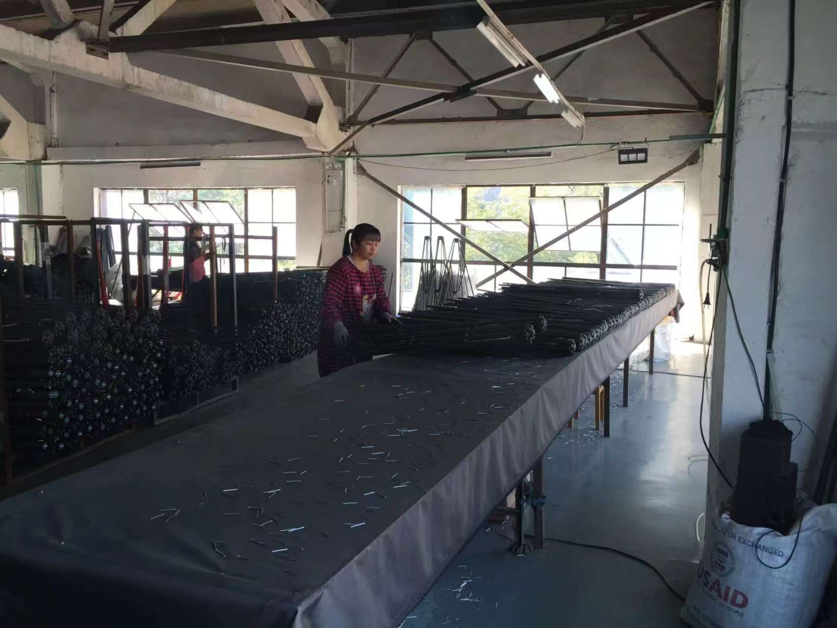 Factory worker assembling commercial outdoor furniture