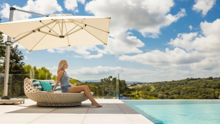 White square cantilever umbrella poolside lounging